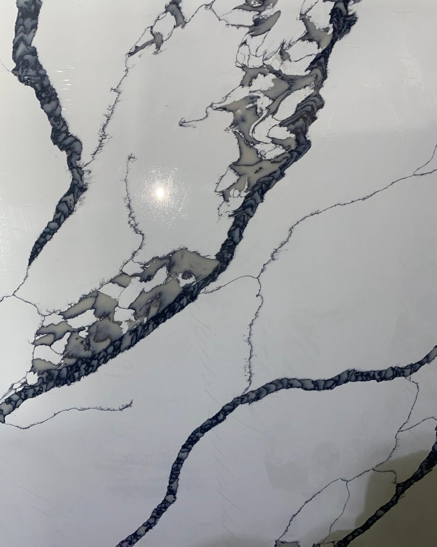 Polished Calacatta Boss quartz slab, grey and black veining on white