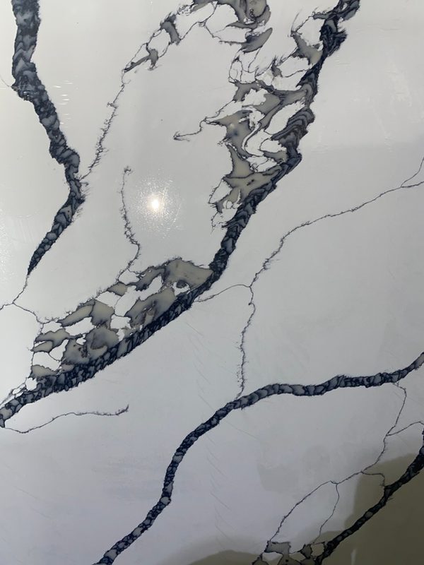 Calacatta Boss quartz slab close-up, white with grey and gold veining